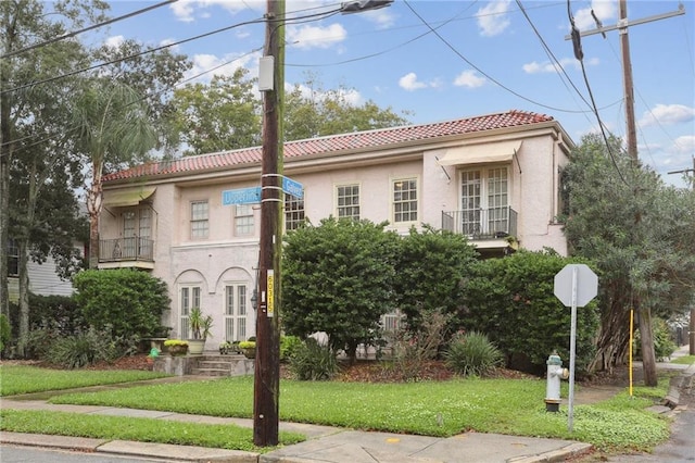 mediterranean / spanish home with a front yard