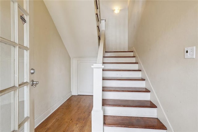 stairs with hardwood / wood-style flooring