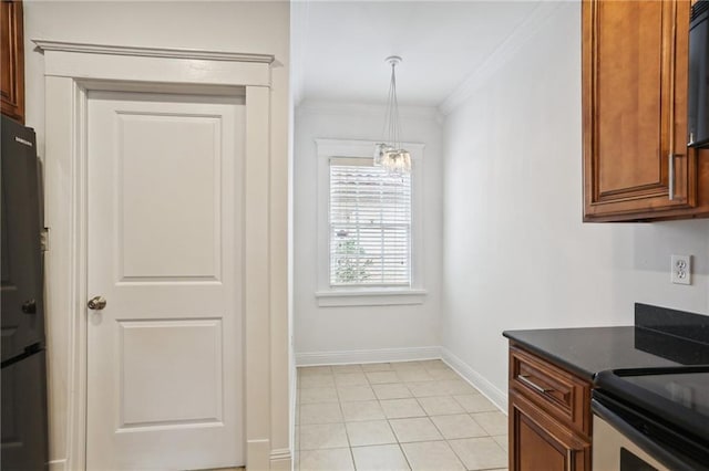 kitchen with a chandelier, fridge, decorative light fixtures, light tile patterned floors, and ornamental molding