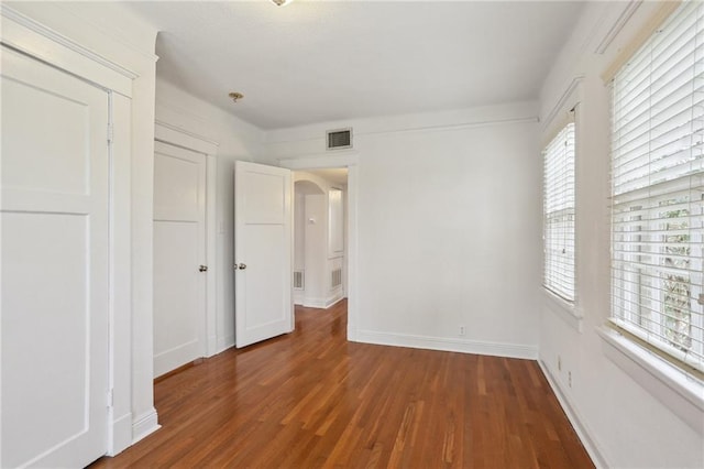 unfurnished bedroom with dark wood-type flooring