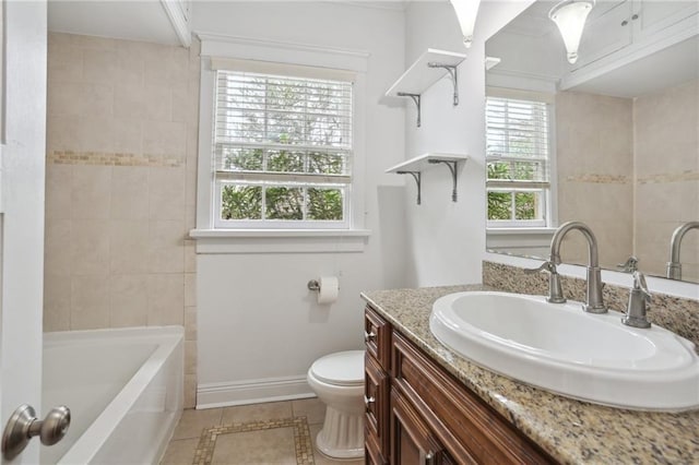 bathroom with toilet, vanity, and tile patterned floors