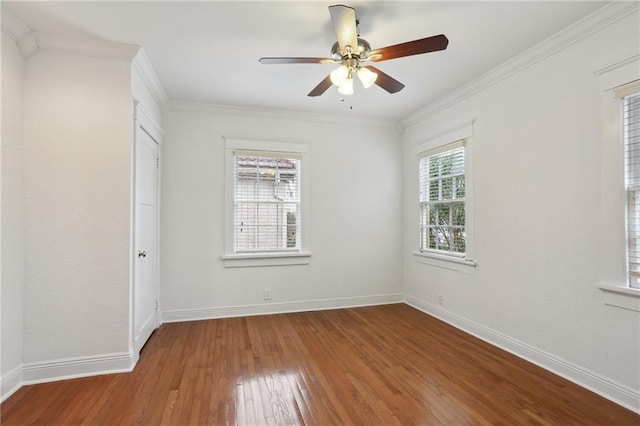 empty room featuring ceiling fan, wood-type flooring, and crown molding