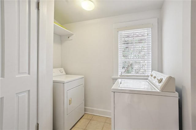 washroom with light tile patterned floors and washing machine and clothes dryer