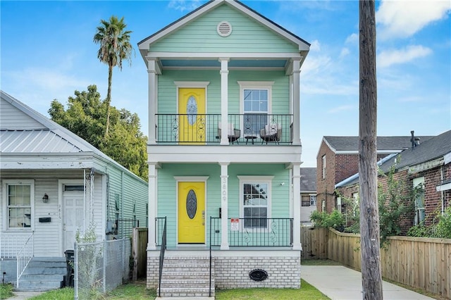 view of front of property featuring a porch and a balcony