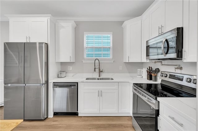 kitchen featuring sink, white cabinets, and appliances with stainless steel finishes