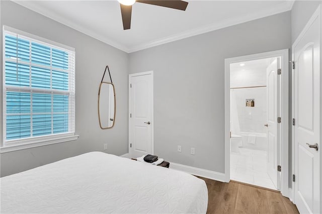 bedroom featuring wood-type flooring, ensuite bathroom, ceiling fan, and ornamental molding