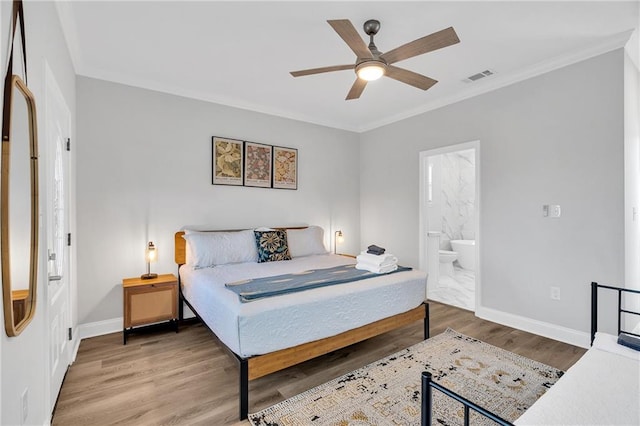 bedroom featuring wood-type flooring, ensuite bathroom, ceiling fan, and ornamental molding