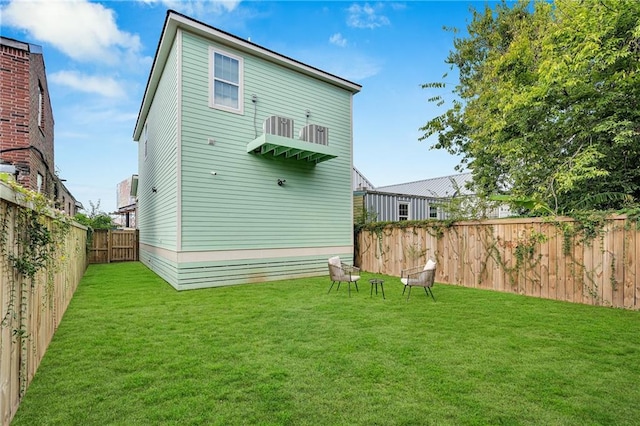 rear view of house with a yard