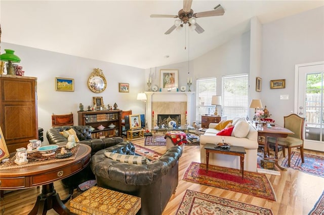 living room with ceiling fan, high vaulted ceiling, and light hardwood / wood-style floors