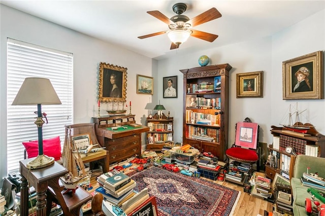 living area with ceiling fan and wood-type flooring