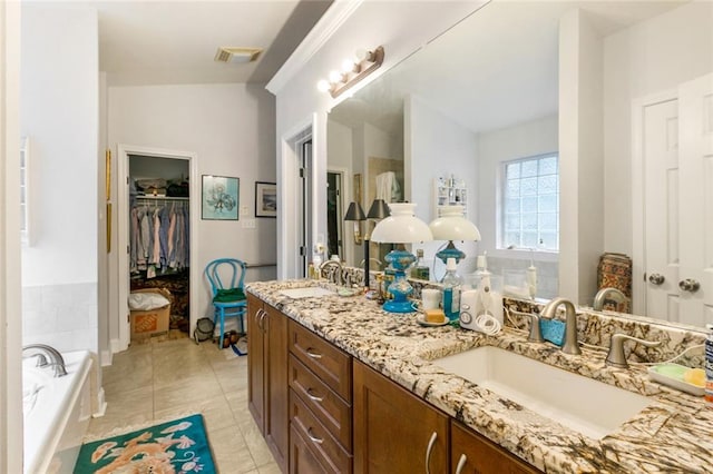 bathroom with tile patterned floors, vanity, a bath, and lofted ceiling