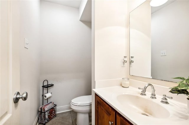 bathroom featuring vanity, toilet, and tile patterned flooring