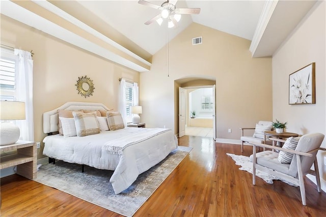 bedroom with lofted ceiling, ensuite bath, wood-type flooring, and ceiling fan