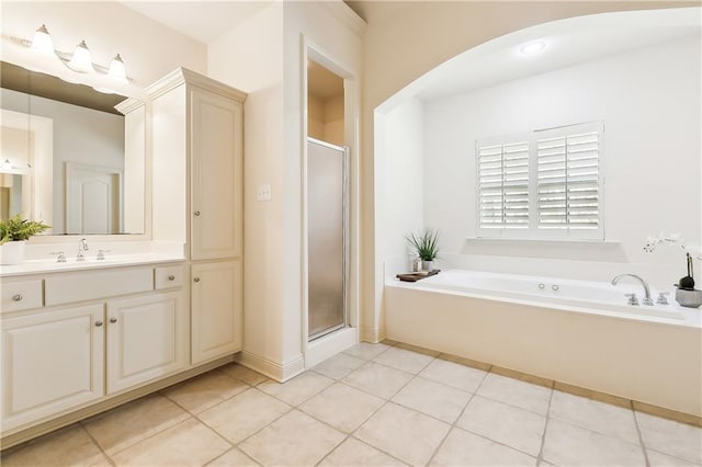 bathroom with tile patterned flooring, vanity, and separate shower and tub