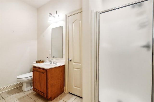 bathroom featuring a shower with door, vanity, tile patterned flooring, and toilet