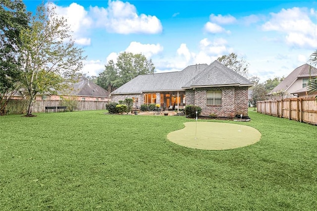 rear view of house featuring a patio and a lawn