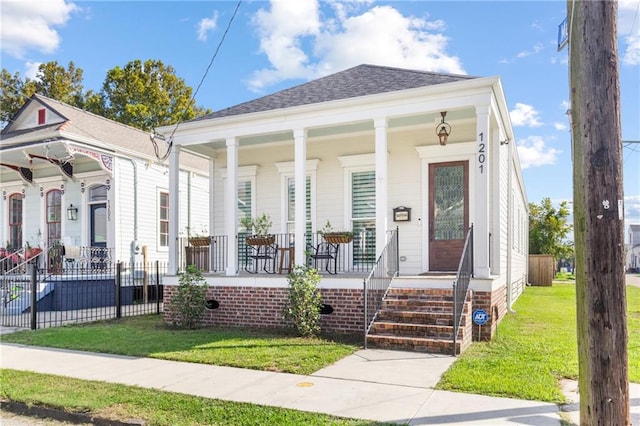 bungalow featuring a porch and a front lawn