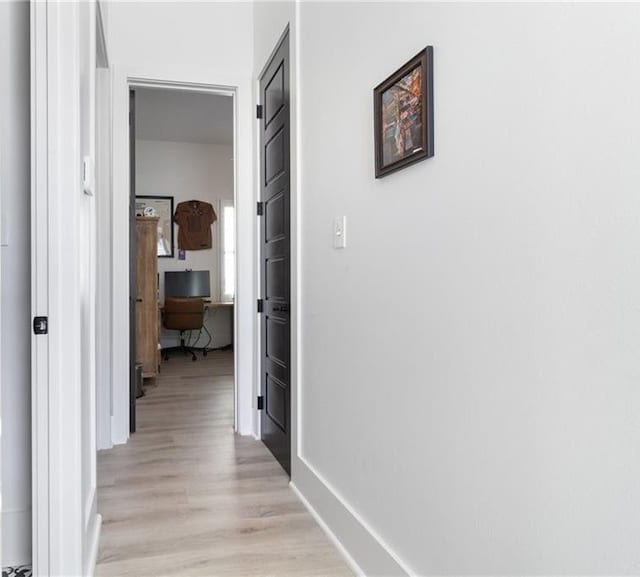 hallway with light hardwood / wood-style flooring