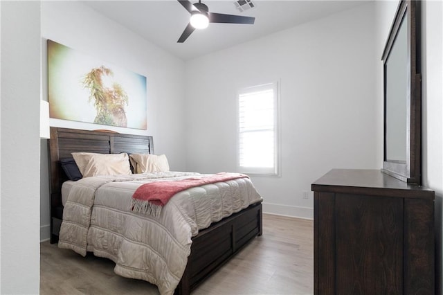 bedroom with ceiling fan and light hardwood / wood-style flooring