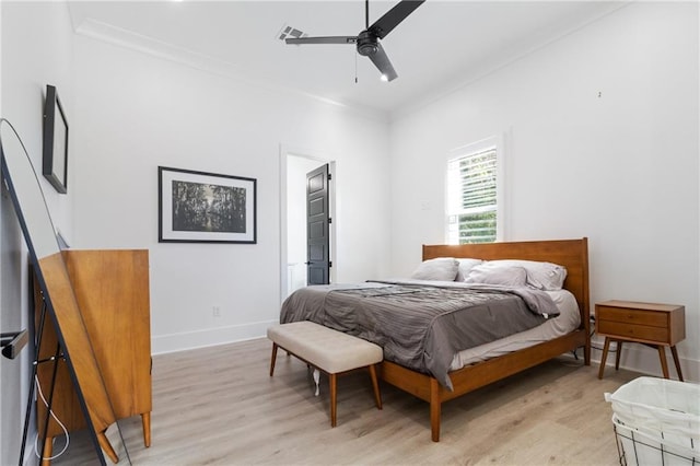 bedroom with ceiling fan, light wood-type flooring, and crown molding