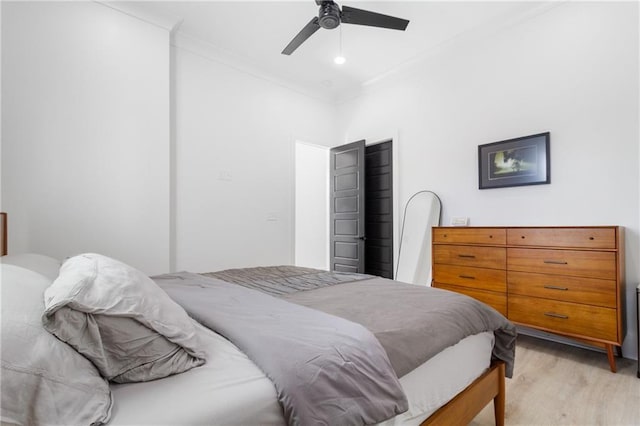 bedroom with ceiling fan, light hardwood / wood-style flooring, and crown molding