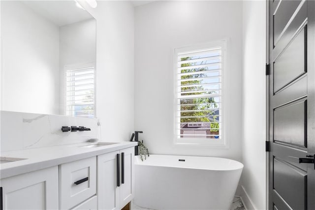 bathroom featuring vanity and a tub to relax in