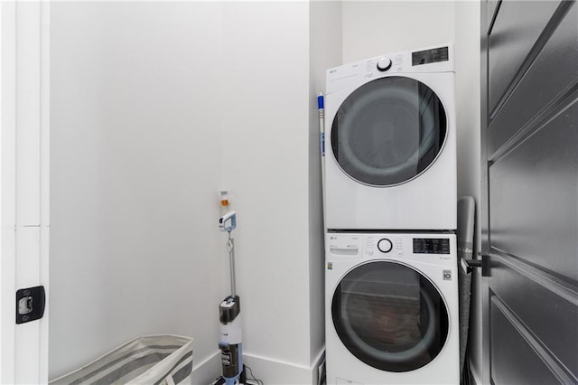 washroom with stacked washer / drying machine