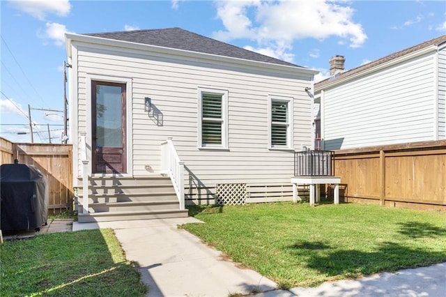 1201 Louisa St, New Orleans, LA 70117 - back of house with a shingled roof