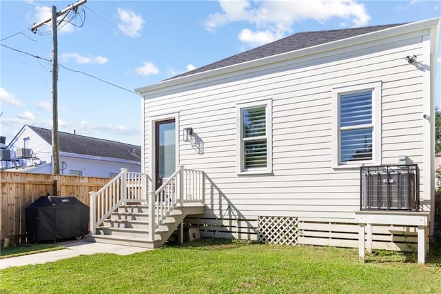 rear view of house with a yard