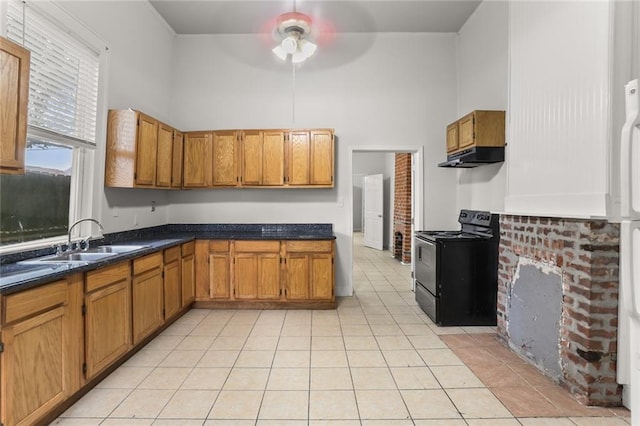 kitchen with ceiling fan, sink, a high ceiling, black electric range oven, and light tile patterned floors