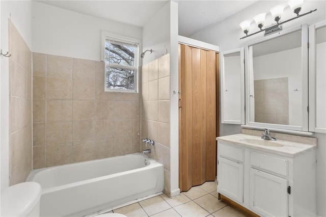 full bathroom with vanity, tiled shower / bath combo, tile patterned floors, and toilet