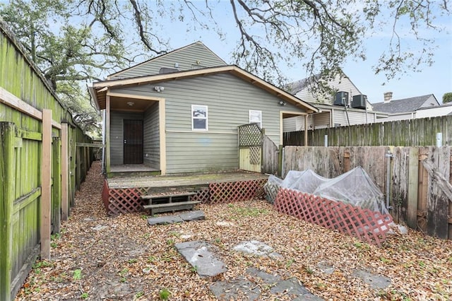 rear view of property with a wooden deck