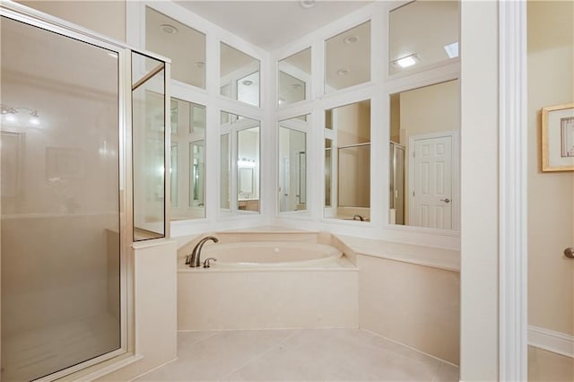 bathroom with tile patterned floors and independent shower and bath