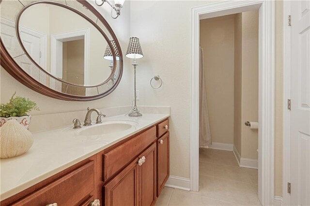 bathroom featuring tile patterned flooring and vanity