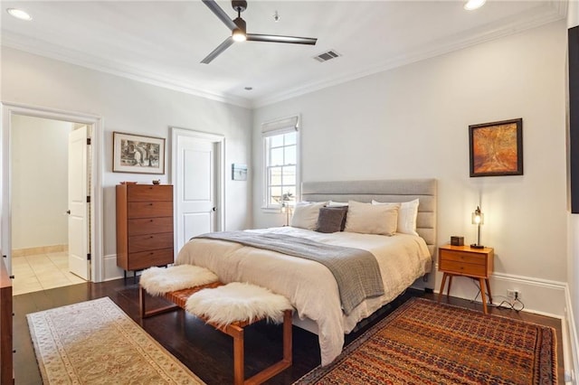 bedroom with hardwood / wood-style flooring, ceiling fan, and ornamental molding