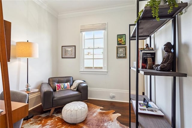 living area featuring wood-type flooring and ornamental molding