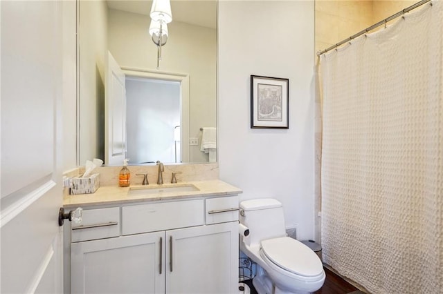 bathroom featuring walk in shower, vanity, and toilet