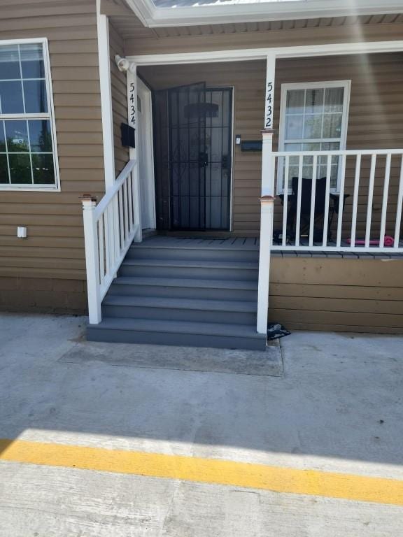 view of exterior entry with covered porch