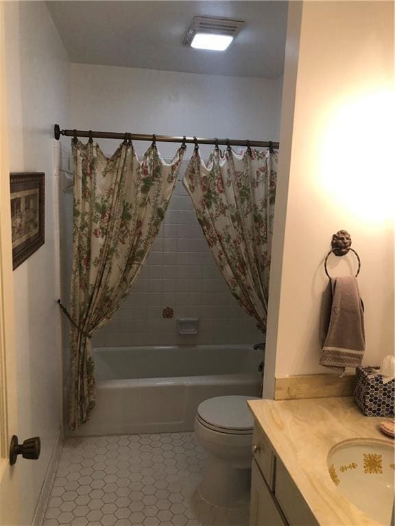 bathroom with toilet, visible vents, vanity, tile patterned floors, and shower / bath combo with shower curtain