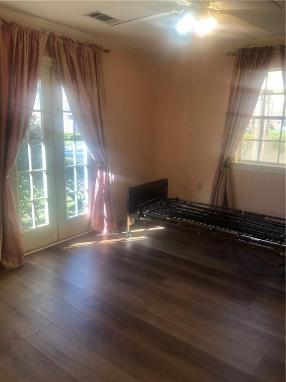 unfurnished room featuring visible vents, ceiling fan, and wood finished floors