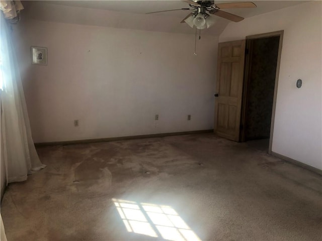 unfurnished room with ceiling fan and baseboards