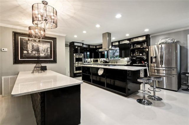 kitchen featuring pendant lighting, ornamental molding, a kitchen island, island exhaust hood, and stainless steel appliances