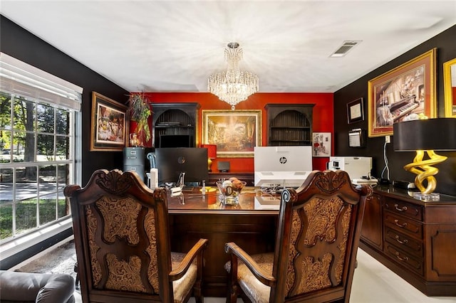 office area with a healthy amount of sunlight and a chandelier