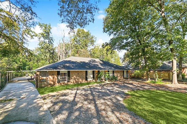 ranch-style home with a front lawn