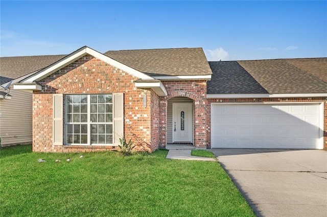 view of front of house with a garage and a front yard