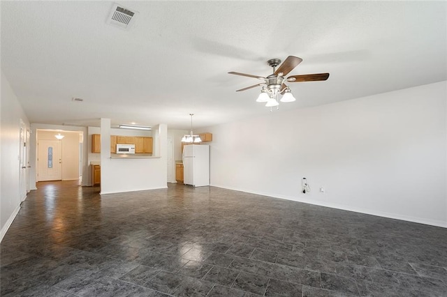 unfurnished living room with ceiling fan with notable chandelier