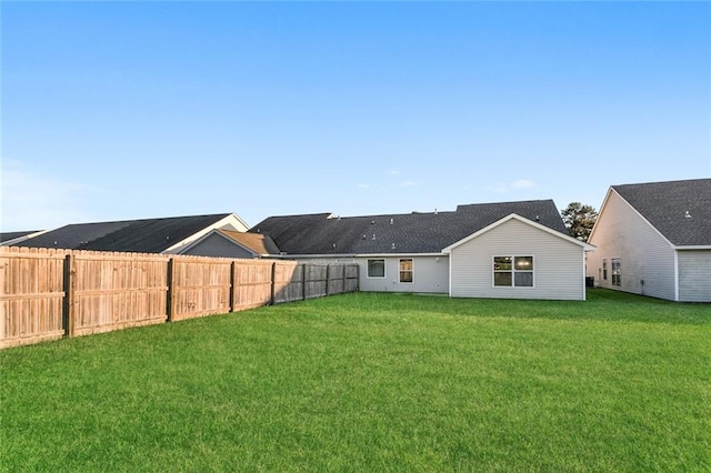 rear view of house with a yard