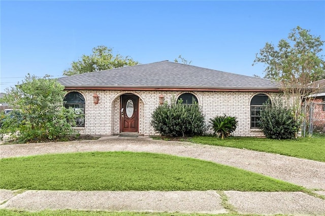 ranch-style house with a front lawn