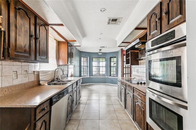 kitchen with backsplash, sink, light tile patterned floors, dark brown cabinets, and stainless steel appliances