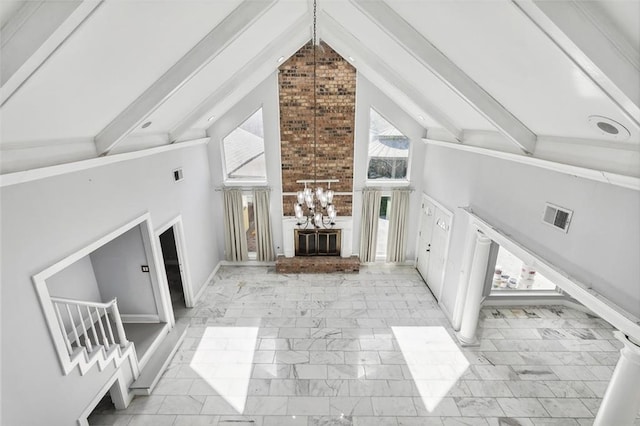 unfurnished living room with beamed ceiling, high vaulted ceiling, and a chandelier